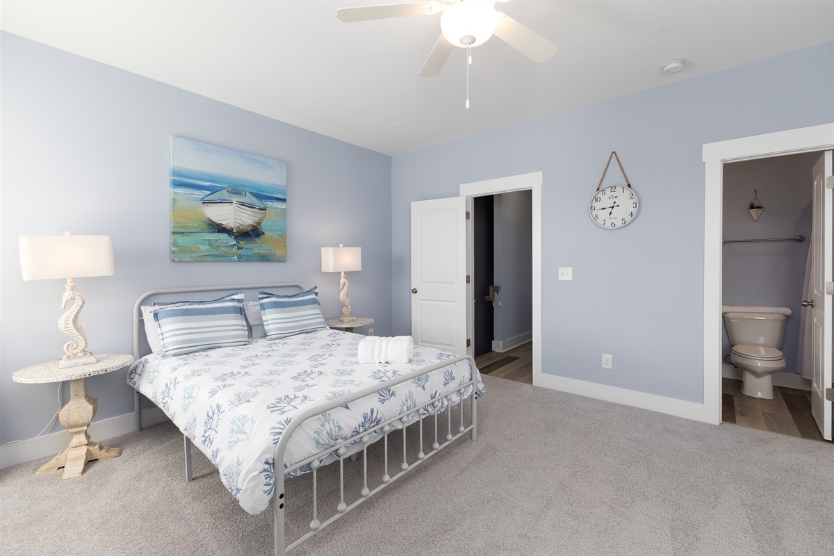 A peaceful retreat with soft linens, natural light, and calming ocean tones throughout the space