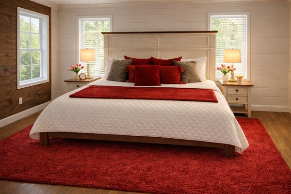 Unwind in style! Bedroom #3 upstairs offers a cozy red ambiance and a picturesque window view.