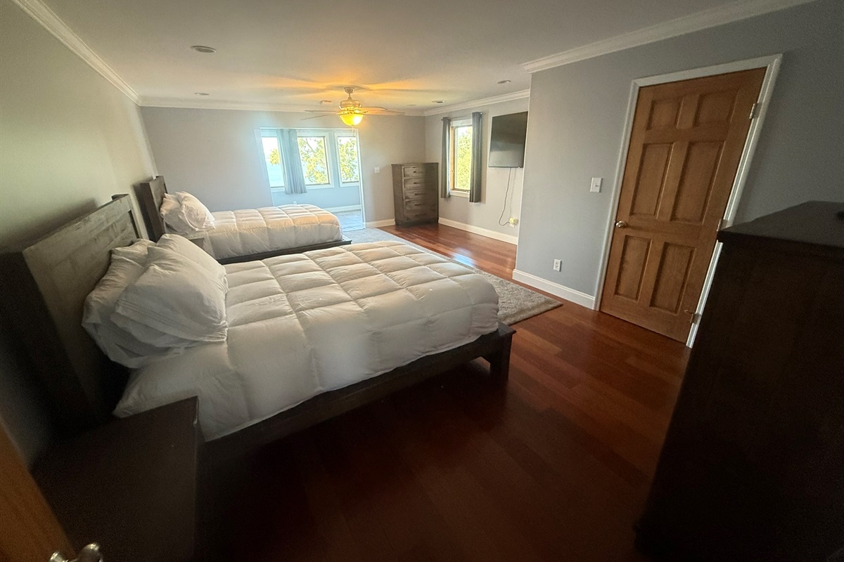 Bedroom 2 with 2 queen beds and a beautiful view of the lake through the bridal room