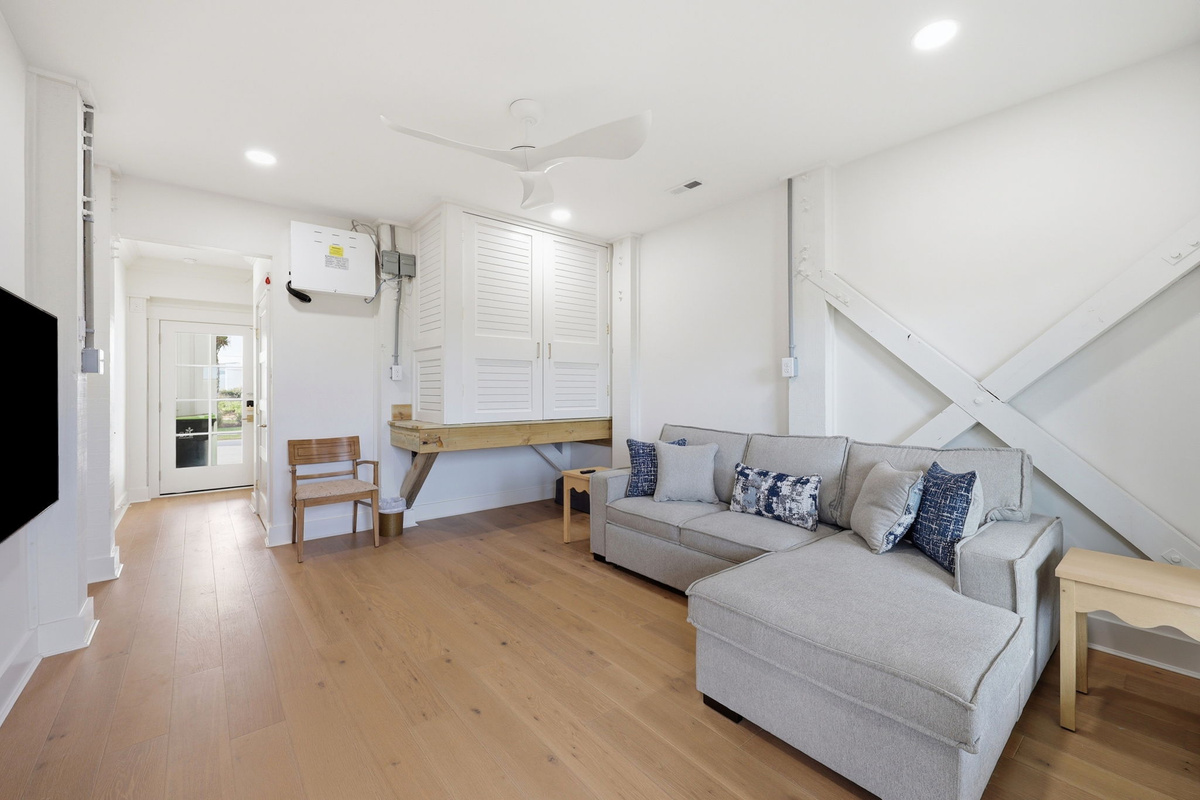 Flex space with sectional seating, built-in storage, and multifunctional layout