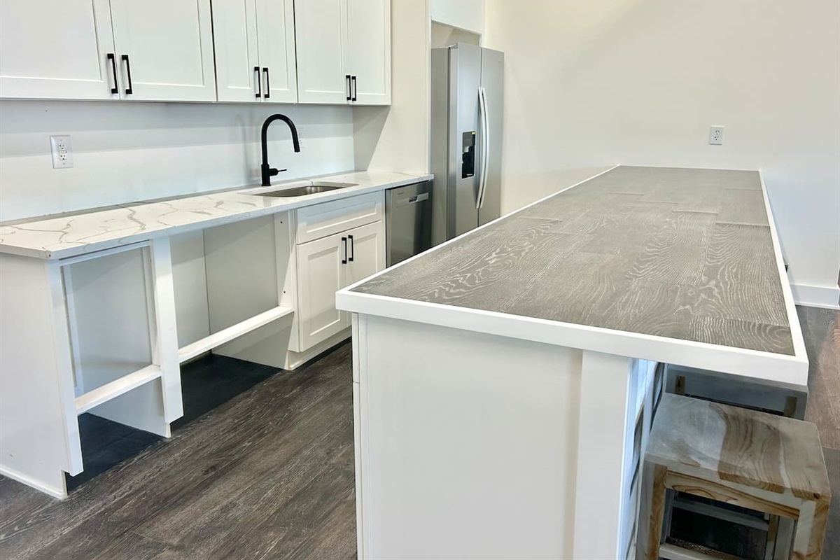 The shared community clubhouse includes a modern kitchenette area, perfect for preparing a quick snack while enjoying the common spaces.