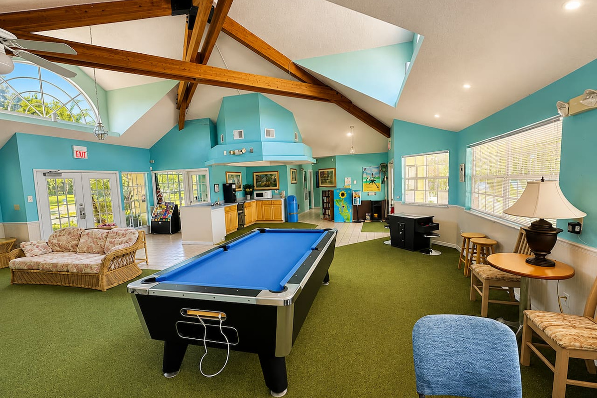 Community clubhouse with a pool table and a comfortable seating area.