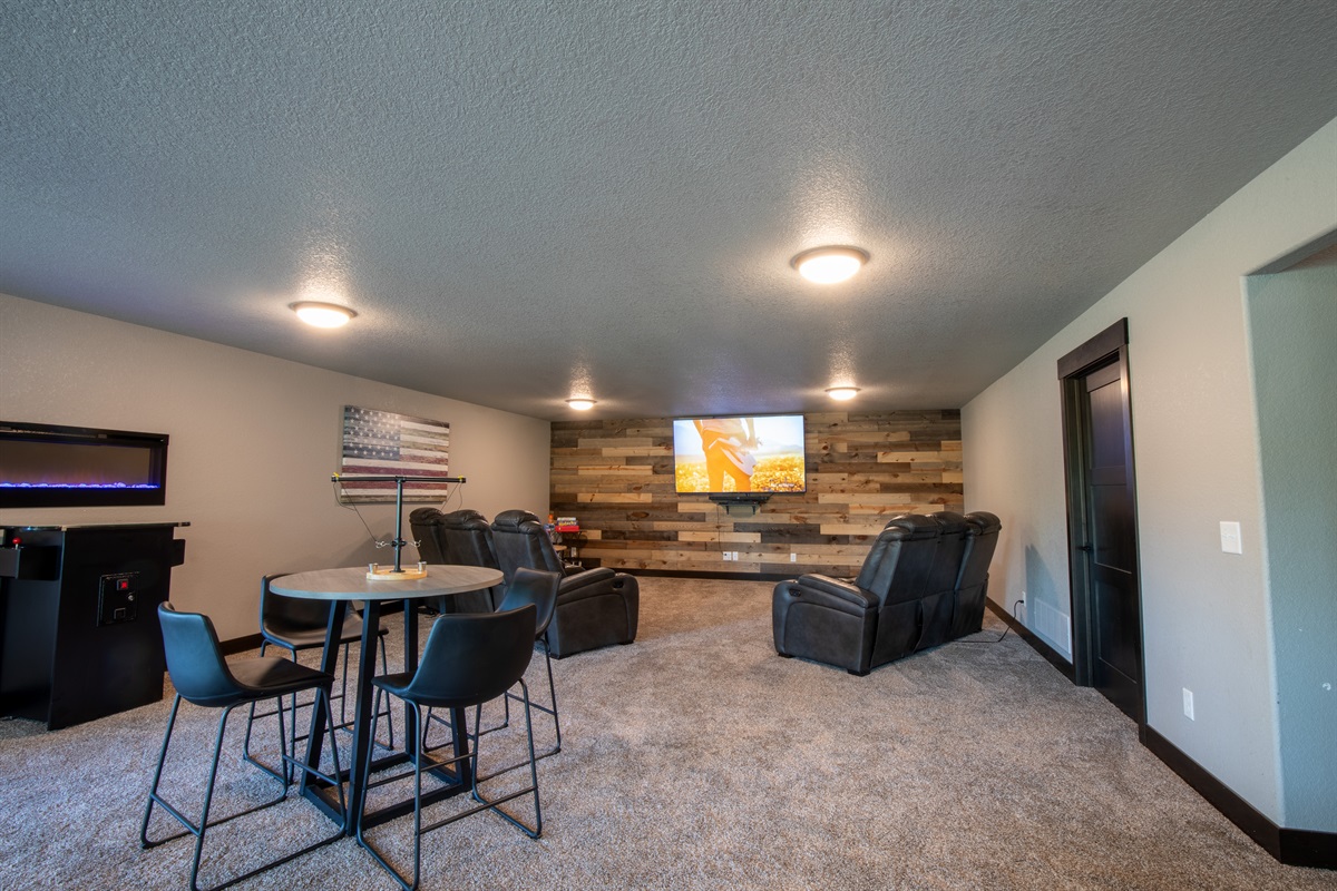Kick back in the lower-level lounge with reclining seats, a big screen TV, retro 64-game arcade, and table games—perfect for movie nights and friendly competition.