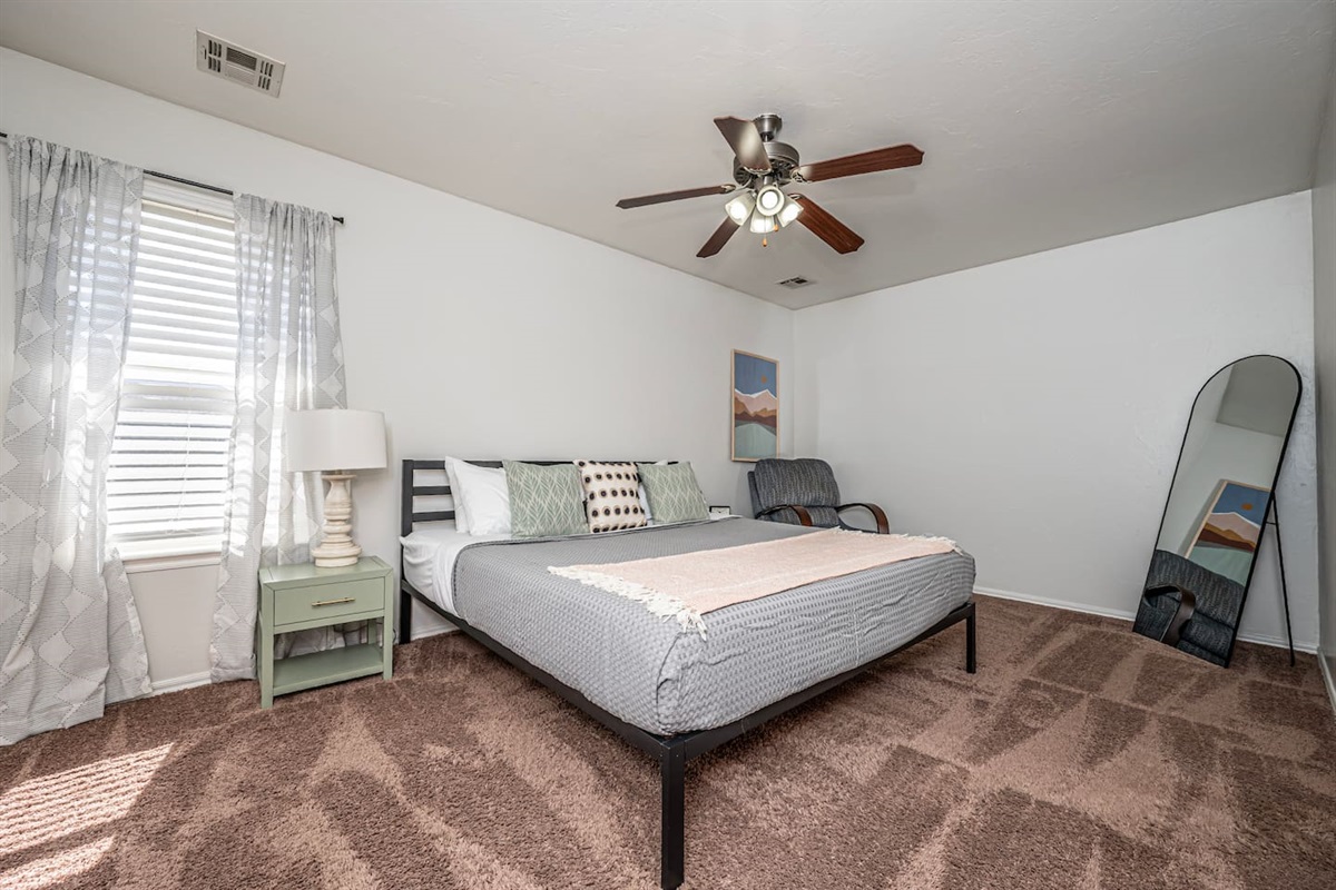 Unwind in your private retreat—master bedroom with a plush king bed.