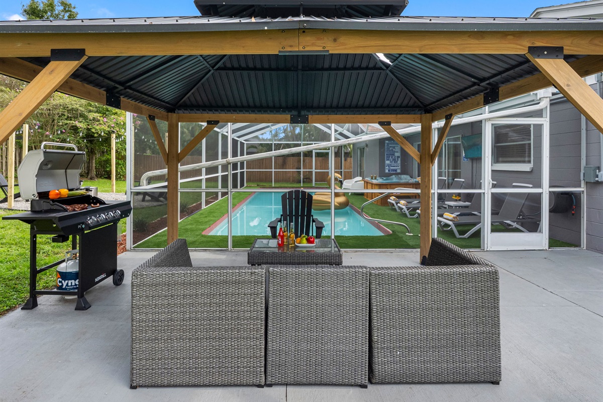 Grill with a view! Just steps from the pool, this space makes it easy to cook, relax, and connect—all in one beautiful setting.