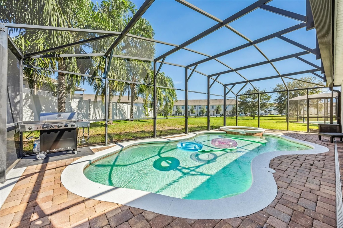 Soak up the Florida sunshine in your own screened-in oasis — featuring a sparkling pool, bubbling spa, and BBQ grill for the perfect day of relaxation and fun.