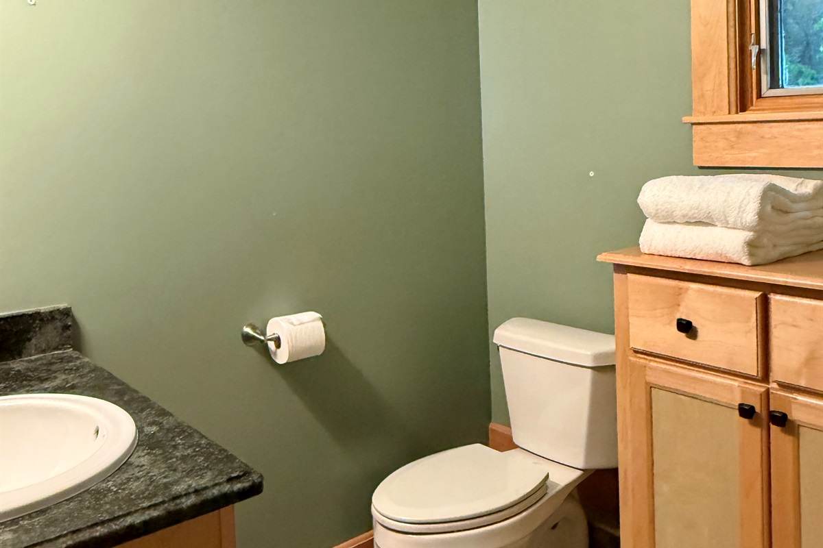 The lower level bathroom has plenty of storage for towels and your toiletries while you are away from home.