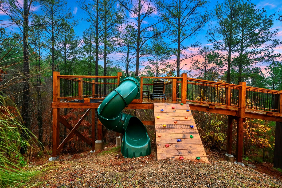 The slide and climbing wall complement the disc swings. 