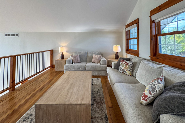 Loft above main living area with sleeper sofa and access to balcony on the front of the house
