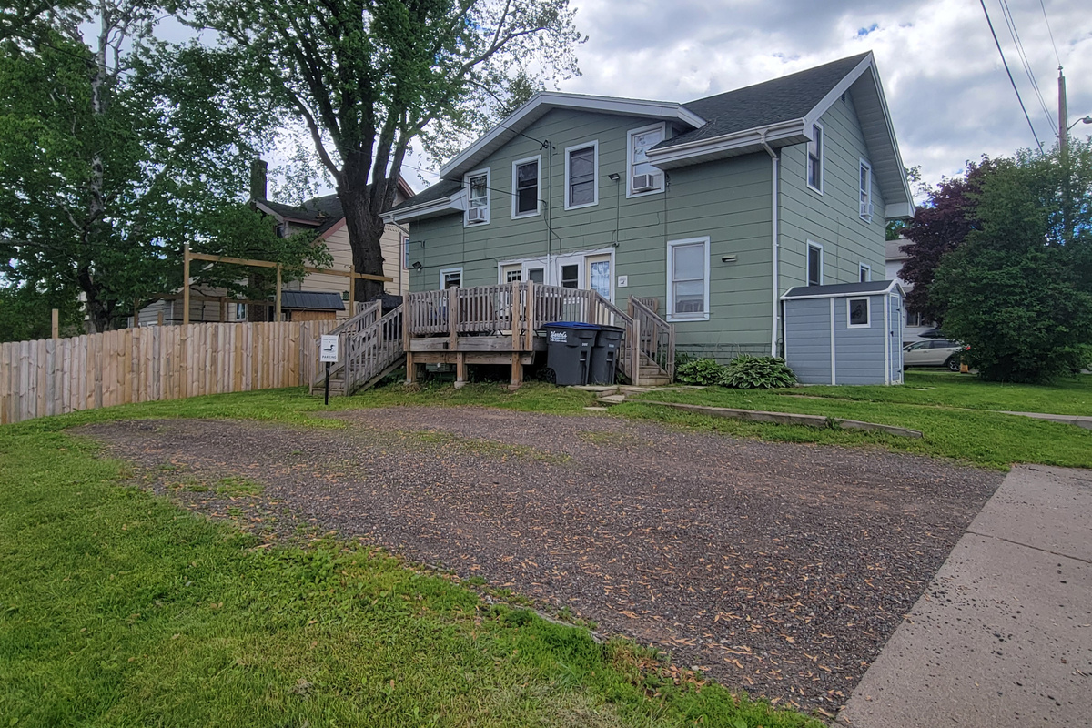 Back deck and parking area at Loon Lookout, part of a side-by-side townhome setting.