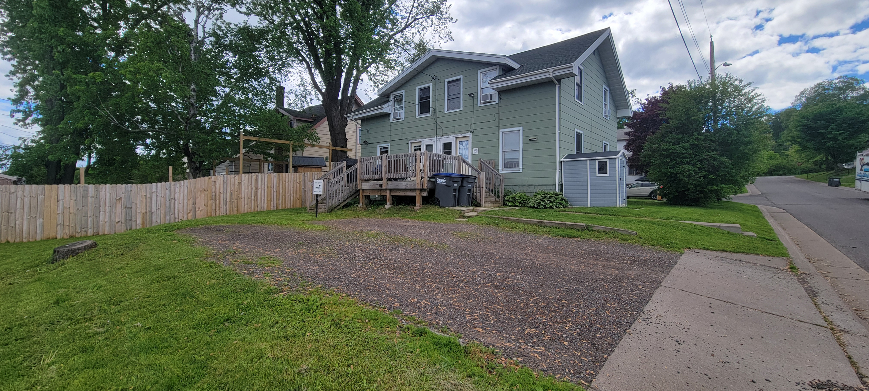 Back deck and parking area at Loon Lookout, part of a side-by-side townhome setting.