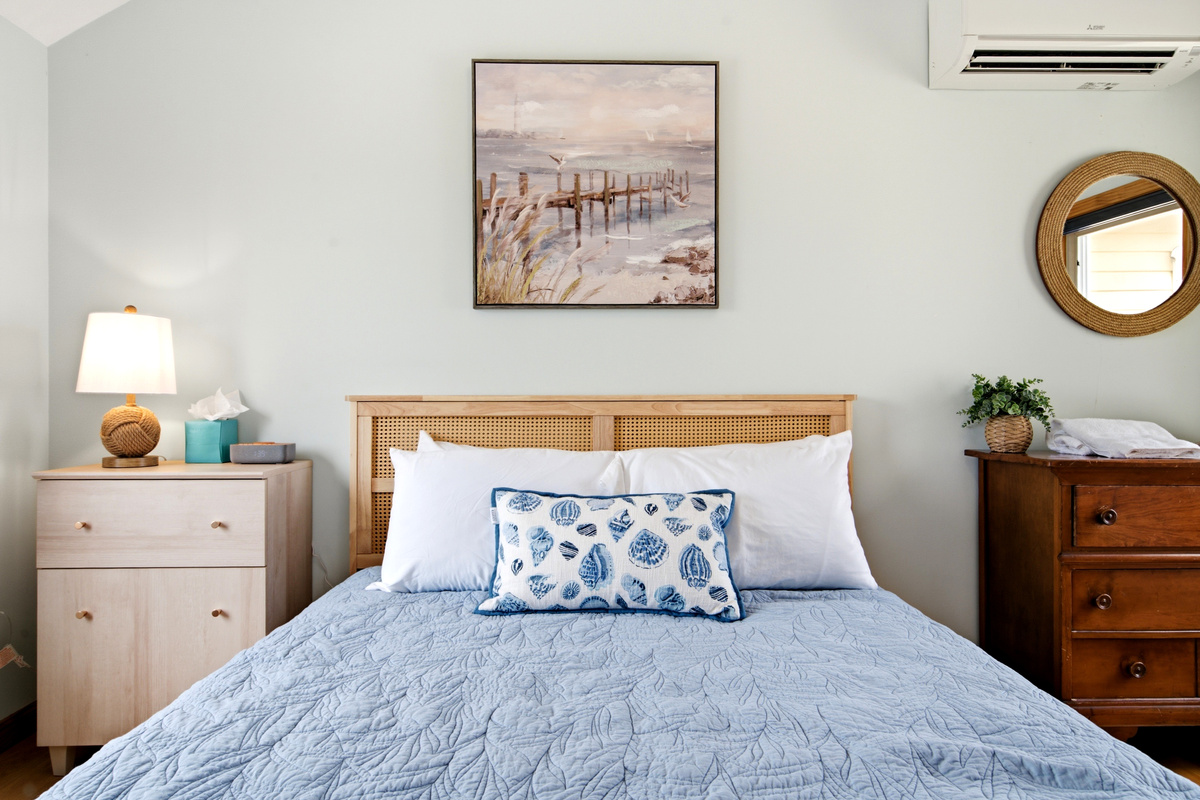 Plush queen bed with comfortable bedding for a restful night's sleep.