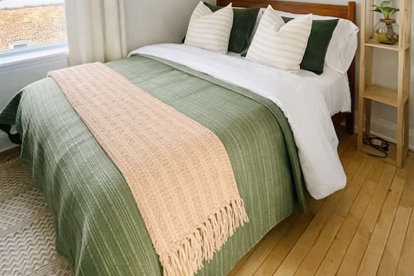 Comfortable Queen bedroom with soft linens and natural light.