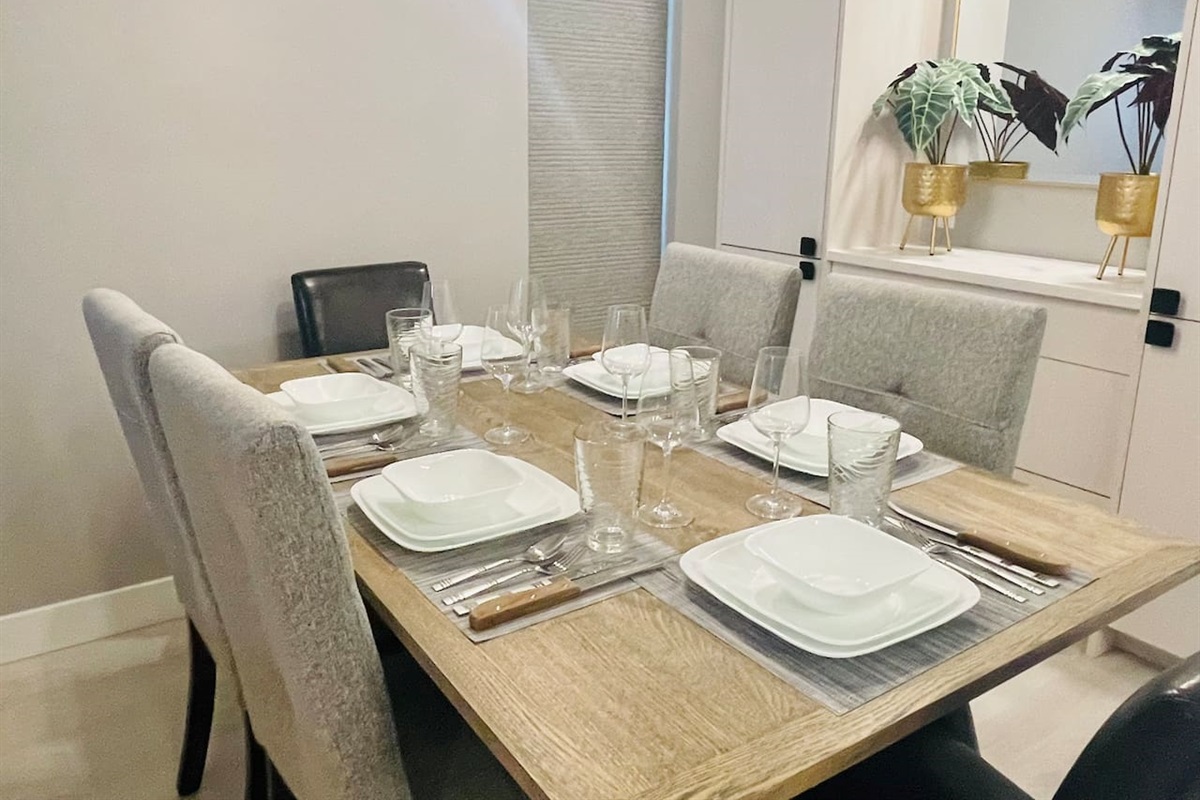 Dining Room Table - can seat up to 6 guests. Extra chairs are stored in Laundry Room and upstairs Bedroom closet. Dinnerware and cutlery set of 6. 
