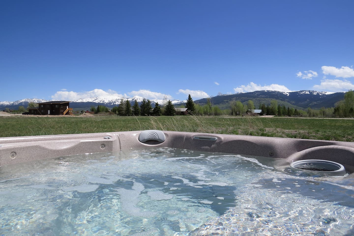 Hot tub steps from house, looking East with views of Grand Targhee Ski Resort and the Teton Range.