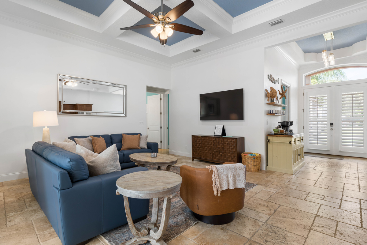 High coffered ceilings and soft seating make the great room an easy place to gather, with the coffee bar close by.
