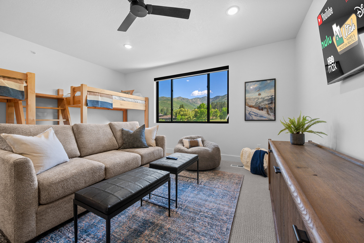 Large upstairs bunk room with lounge area, Smart TV, and mountain views.