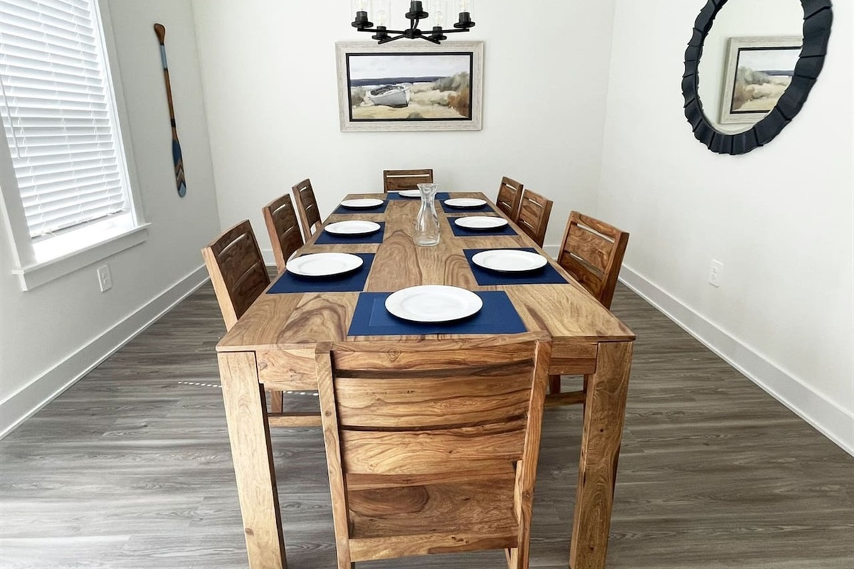 Gather around the spacious dining table with seating for family meals, game nights, or planning your beach adventures.