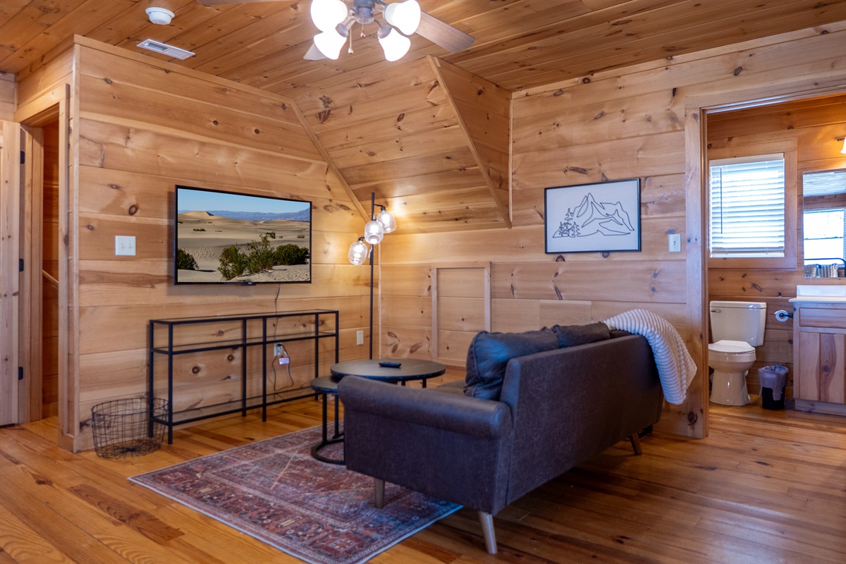 Enjoy a quiet moment or watch your favorite show from the cozy seating area within the primary suite.