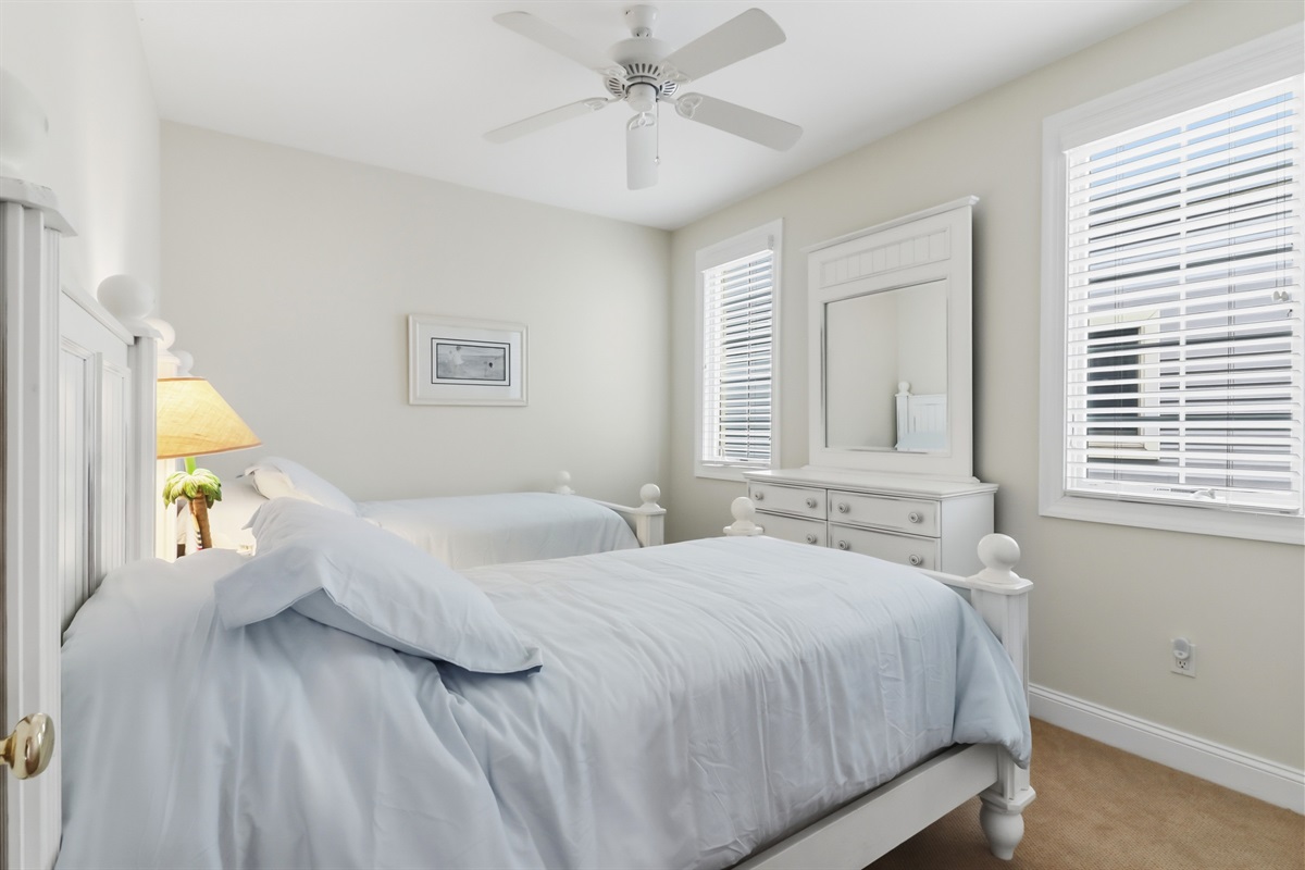 Two twin sized beds and a dresser