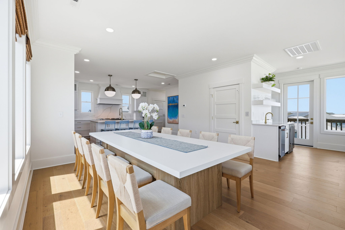 Open coastal layout connecting kitchen, dining, and living spaces for effortless entertaining