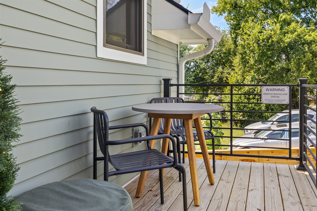 Balcony seating with café-style table and chairs for al fresco dining.