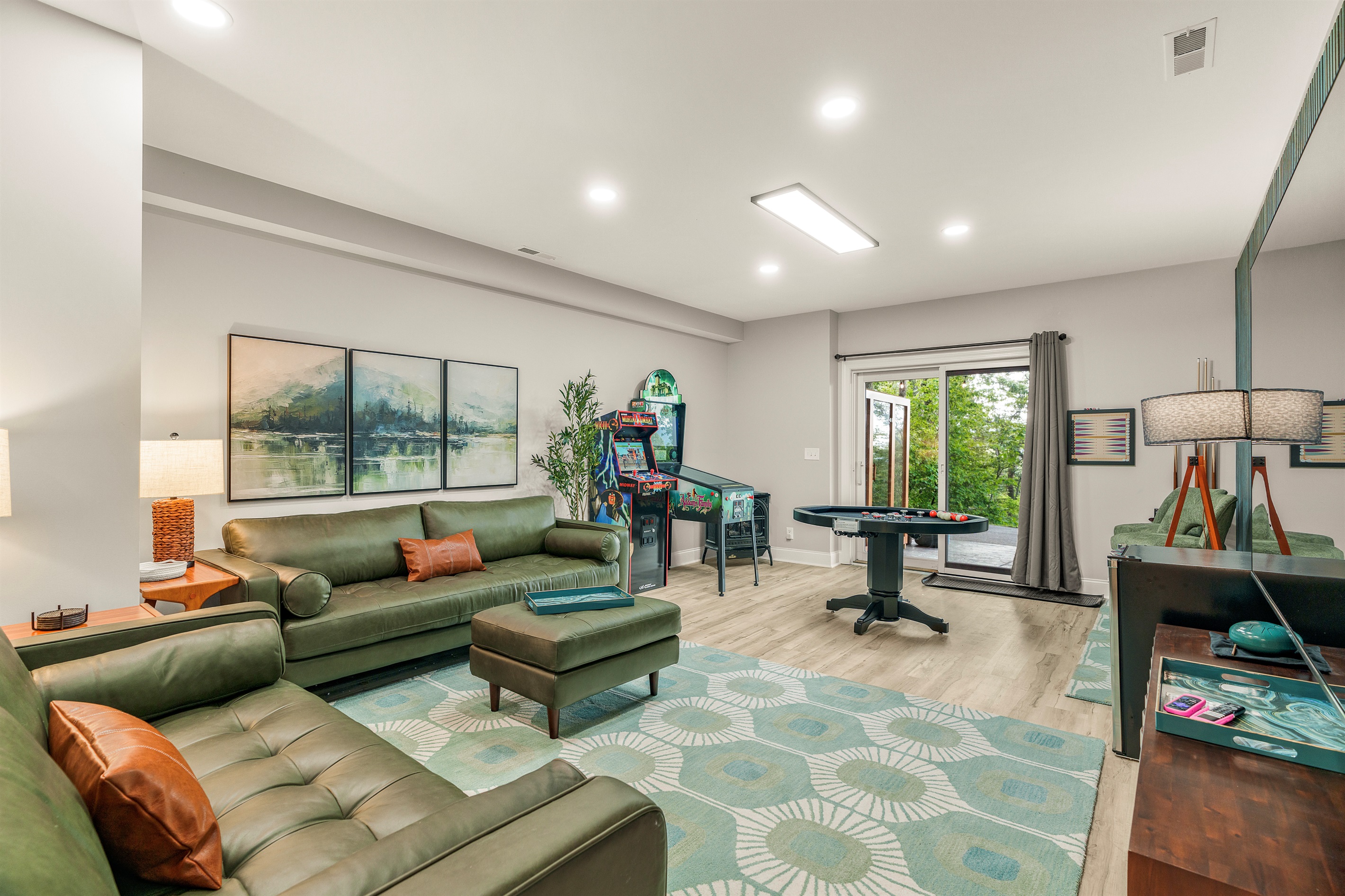 Retro arcade, combo bumper pool/poker table, and curated mid-century lounge — this game room blends fun and style for all ages