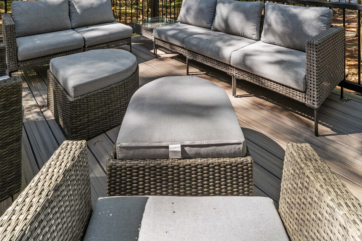 A comfortable patio couch paired with a matching table creates an inviting outdoor spot to unwind,
