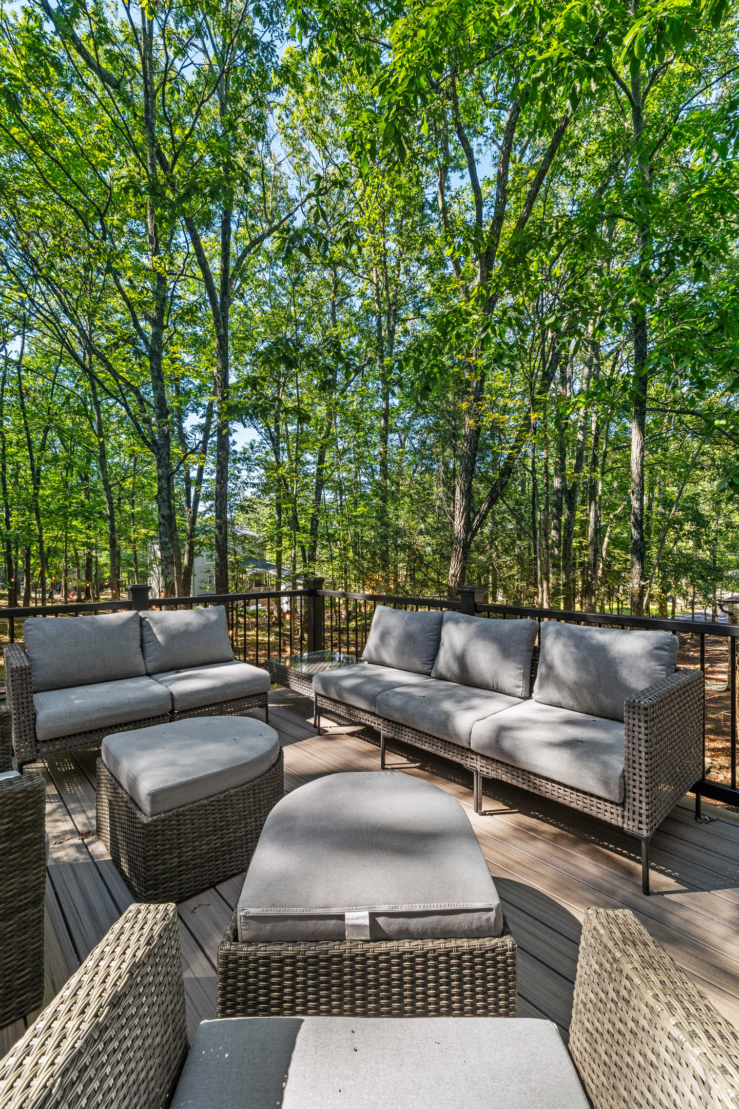 A comfortable patio couch paired with a matching table creates an inviting outdoor spot to unwind,