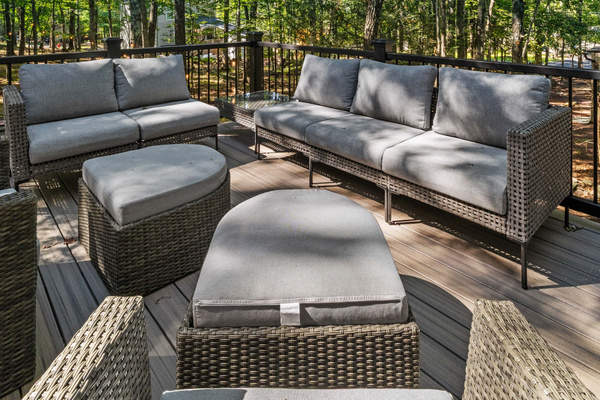 A comfortable patio couch paired with a matching table creates an inviting outdoor spot to unwind,