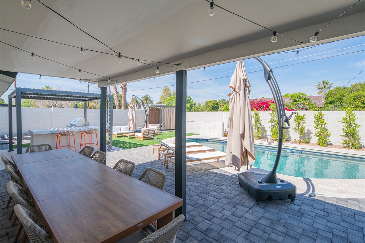 Spacious covered dining area overlooking the pool and backyard
