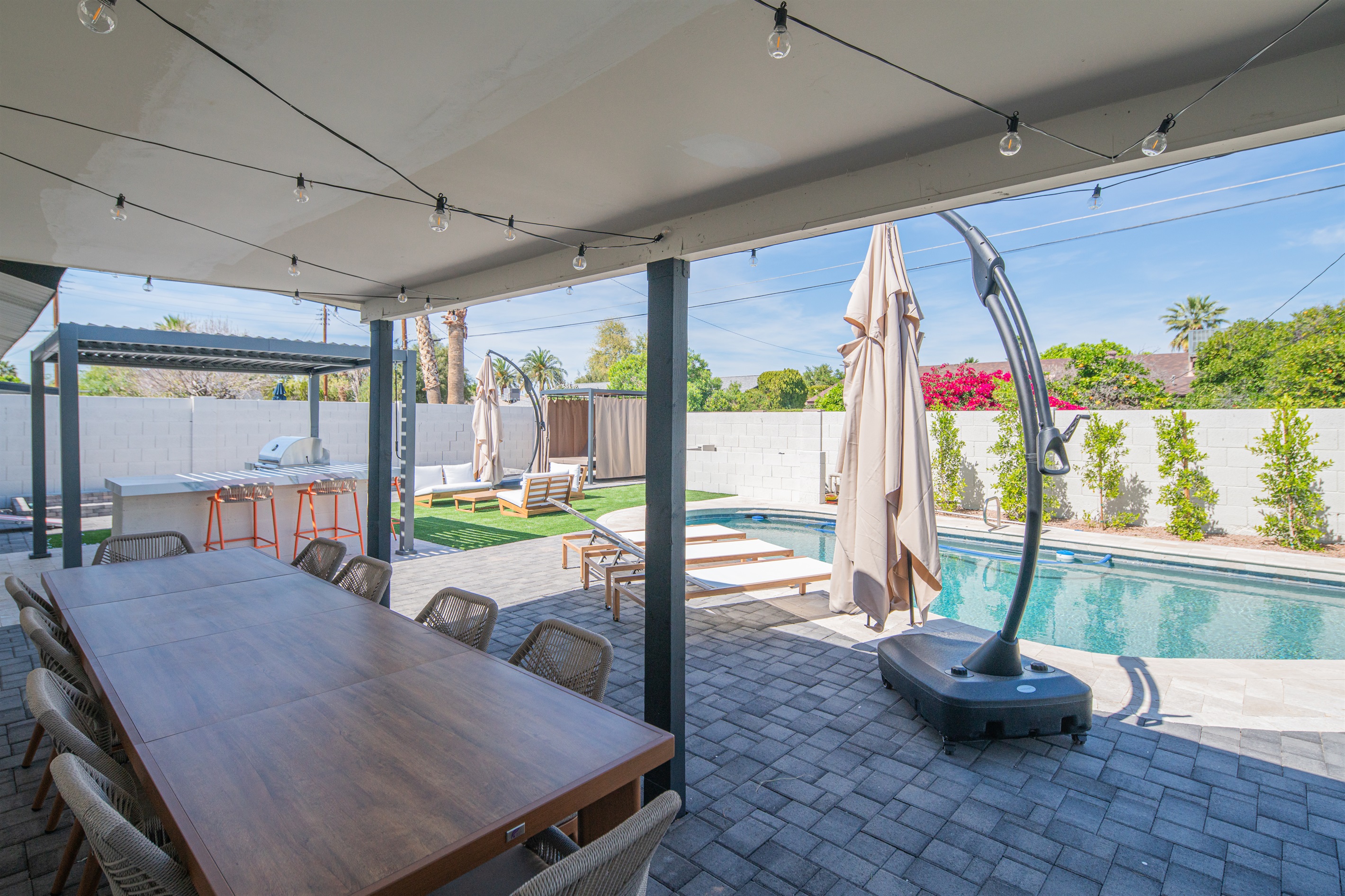 Spacious covered dining area overlooking the pool and backyard