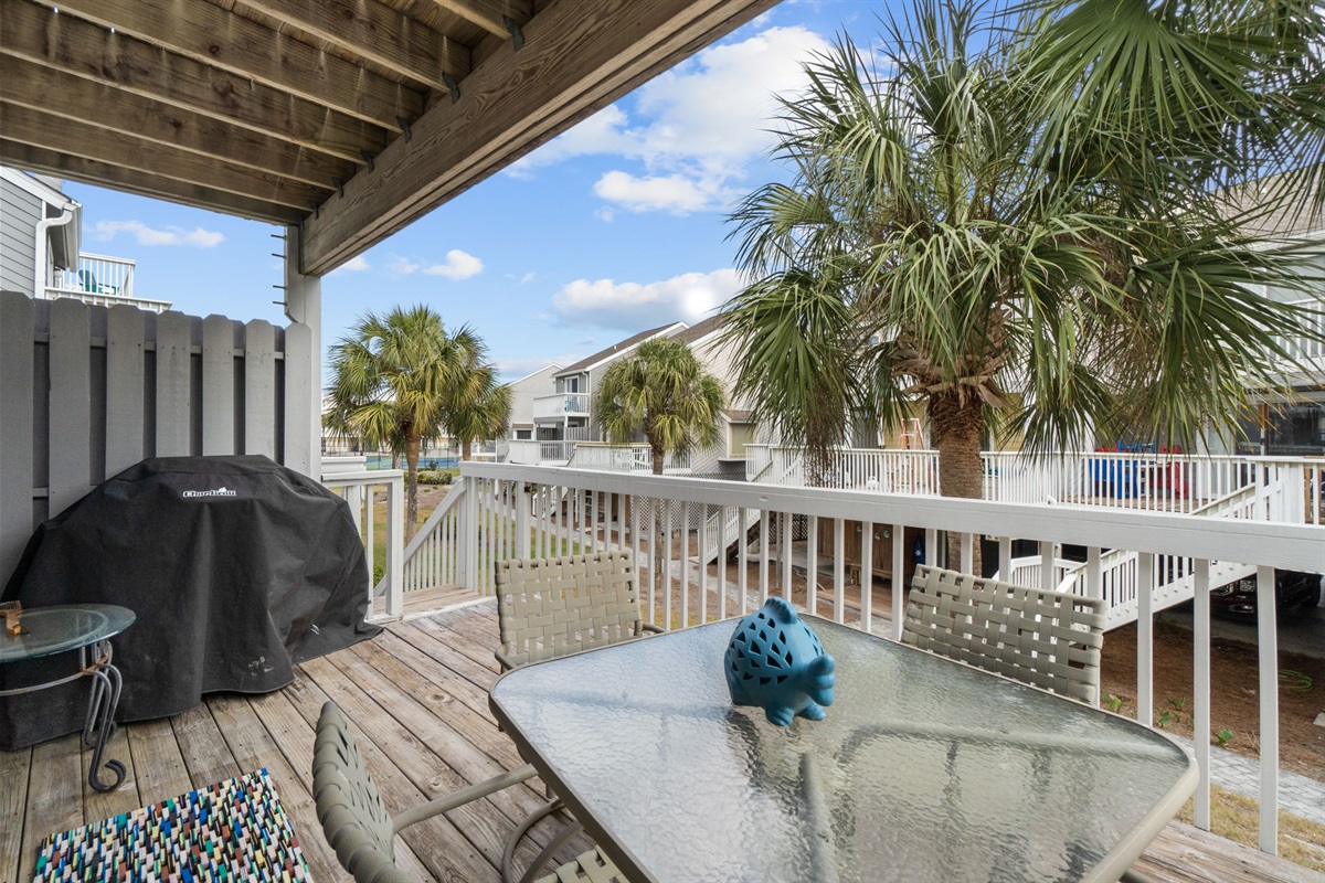 Deck off living room with gas grill and outdoor seating