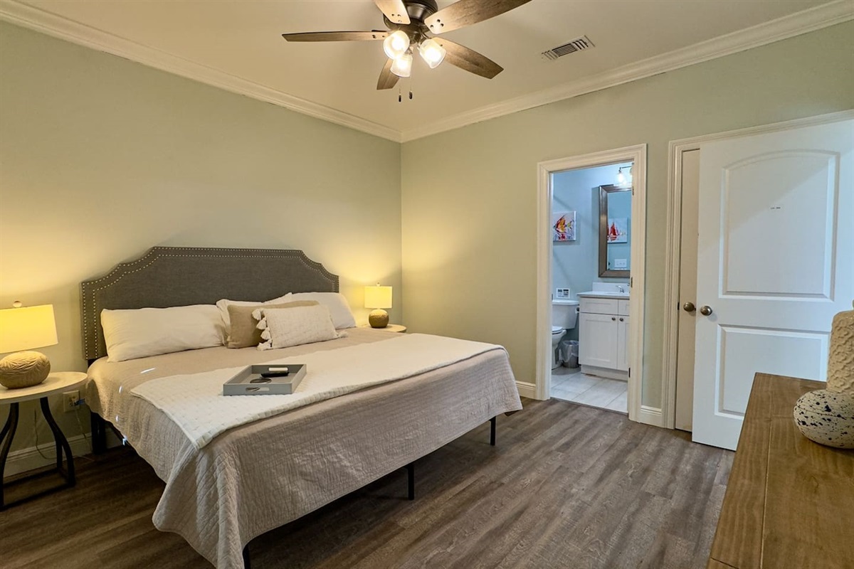 A bedroom that blends warmth, color, and functionality with its own ensuite bathroom.