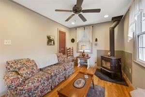 Living room with floral couch and indoor fire fit ( Not in use)