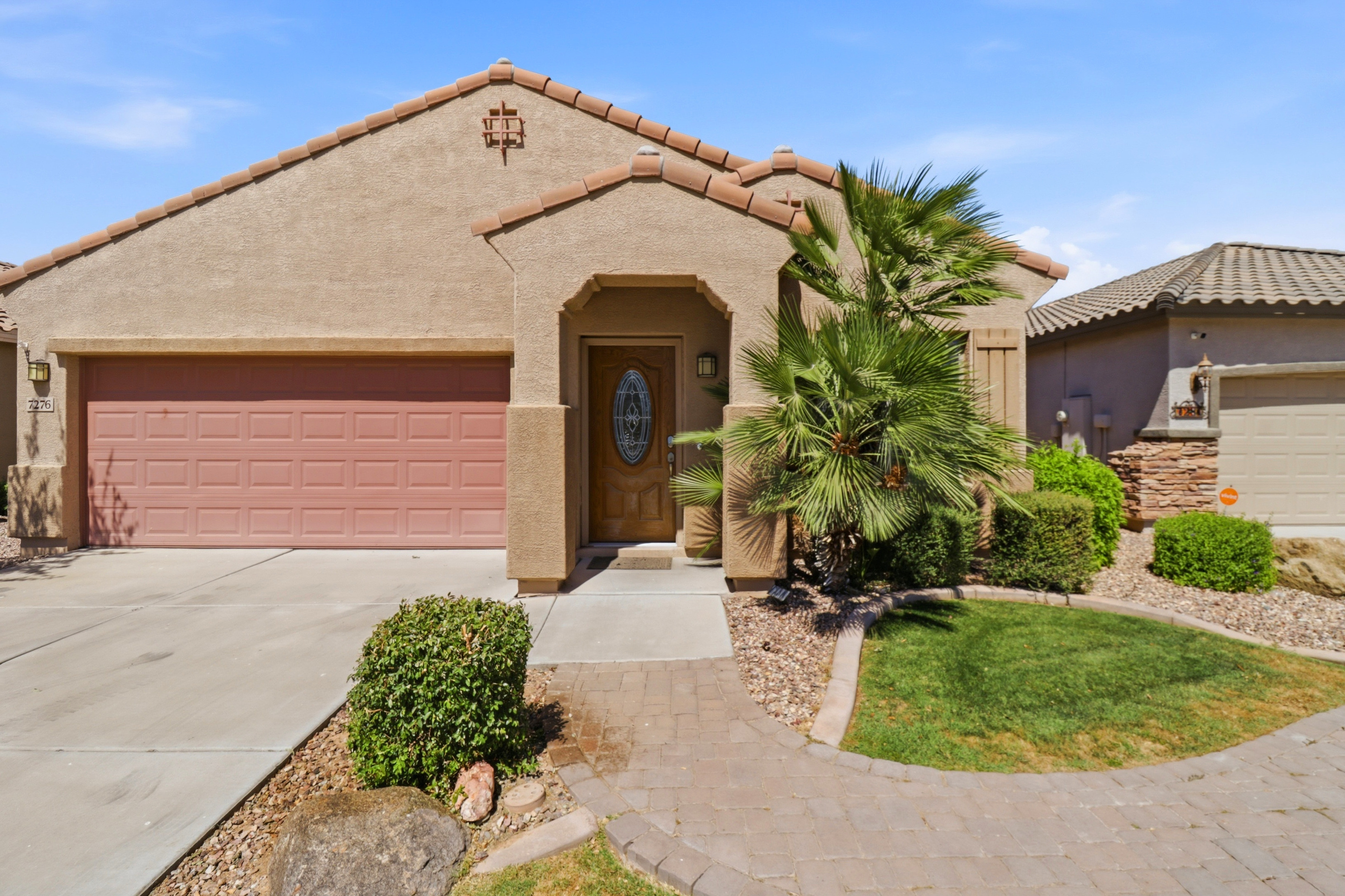 Front exterior with driveway parking for up to 2 cars and a private entrance.
