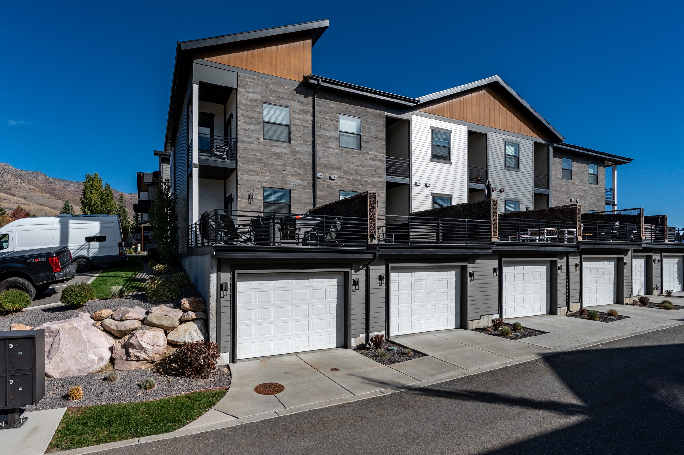 Rear view showing garage access and parking area.