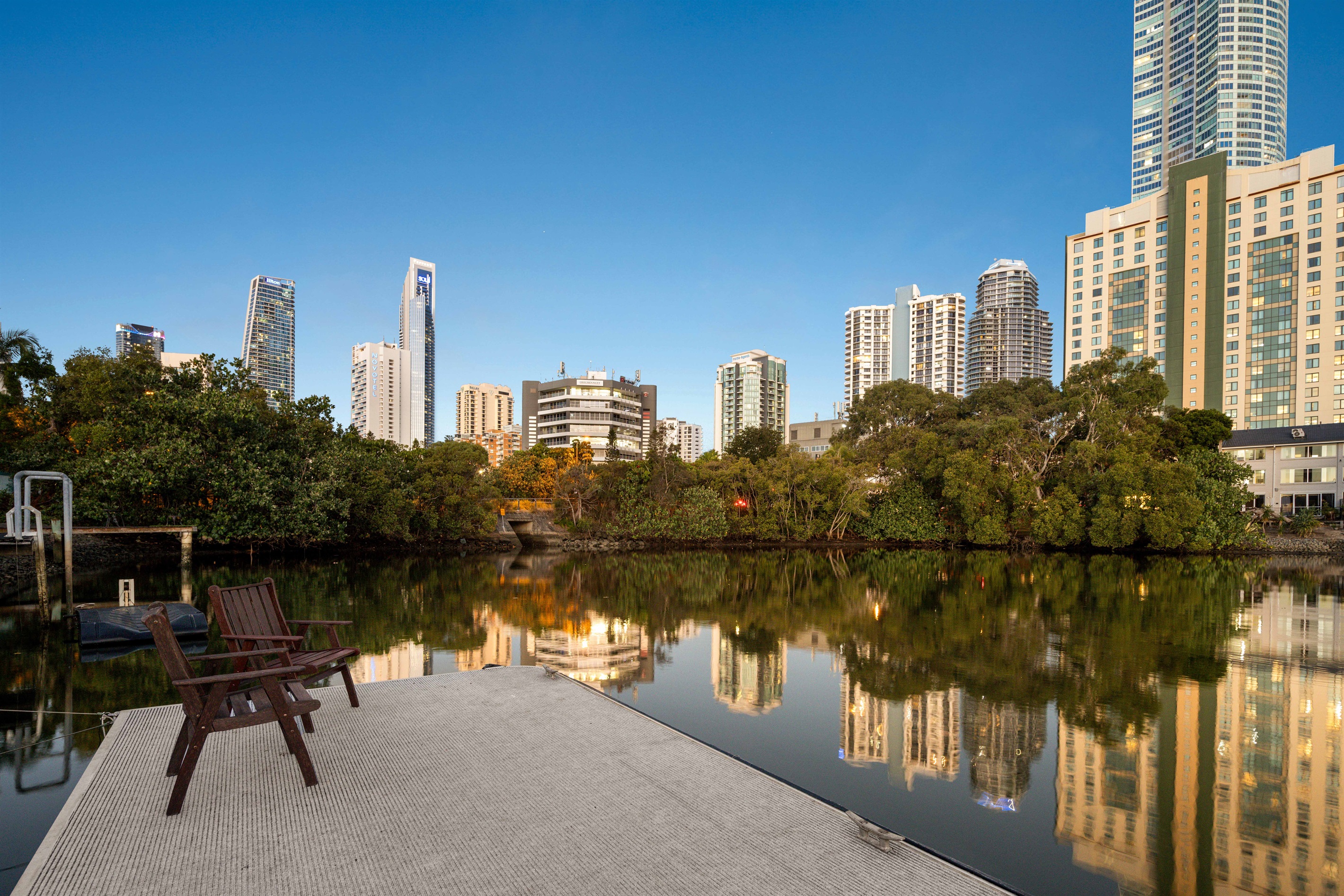 Evening reflections from your private jetty overlooking the illuminated skyline.