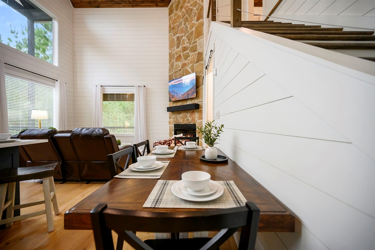 Another angle of the dining space highlighting the open-concept design and natural light.