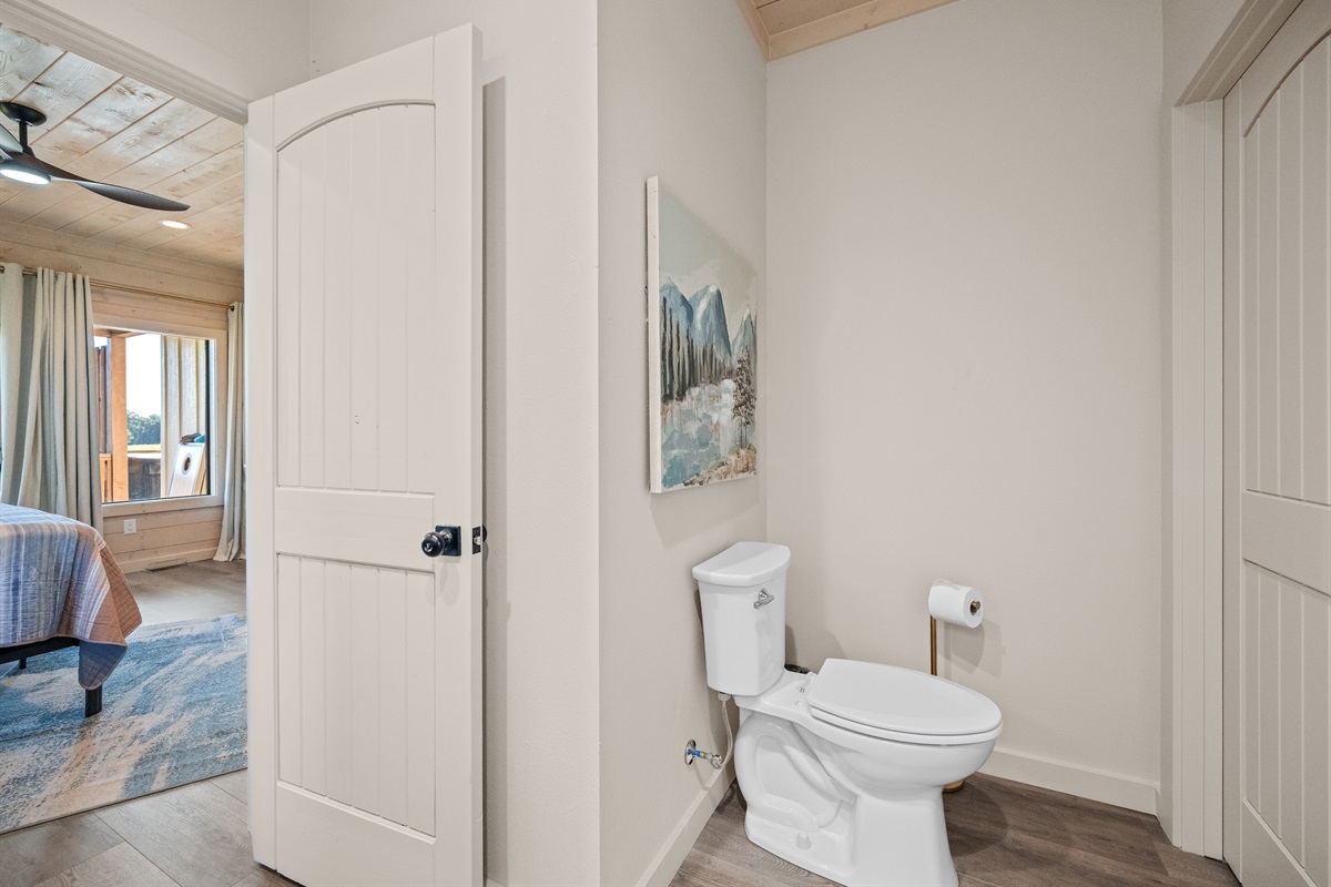 Half bath with modern finishes for guests’ convenience.