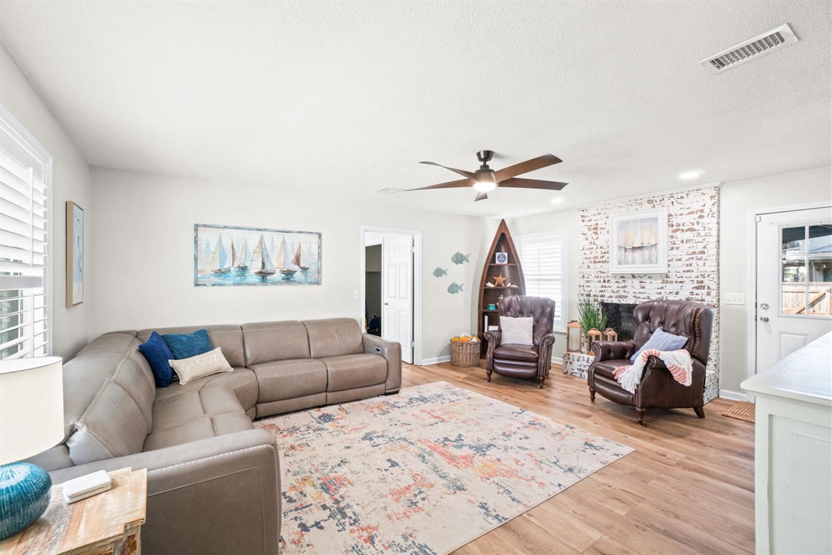 Spacious living area with sectional couch and chairs