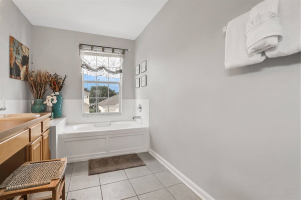 Master bathroom with double vanities, shower booth and soaking bath tub