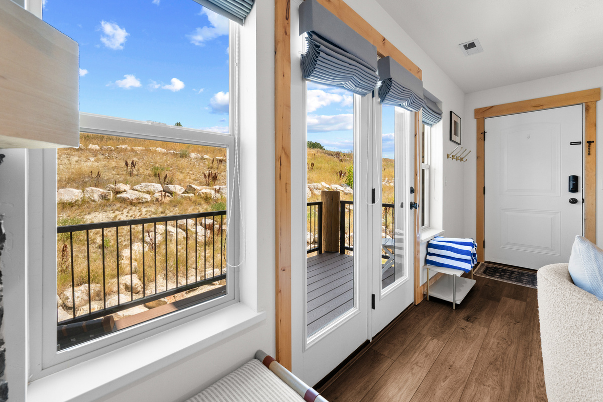 Natural light and direct balcony access bring the mountain setting right into the home.