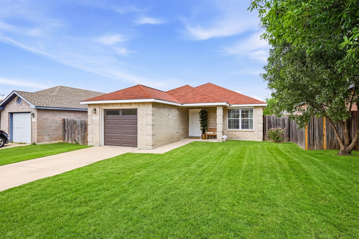 Spacious front yard with freshly cut grass, garage access, and covered entry. Fully fenced property in a peaceful Northwest San Antonio neighborhood near Culebra Road shopping and dining.