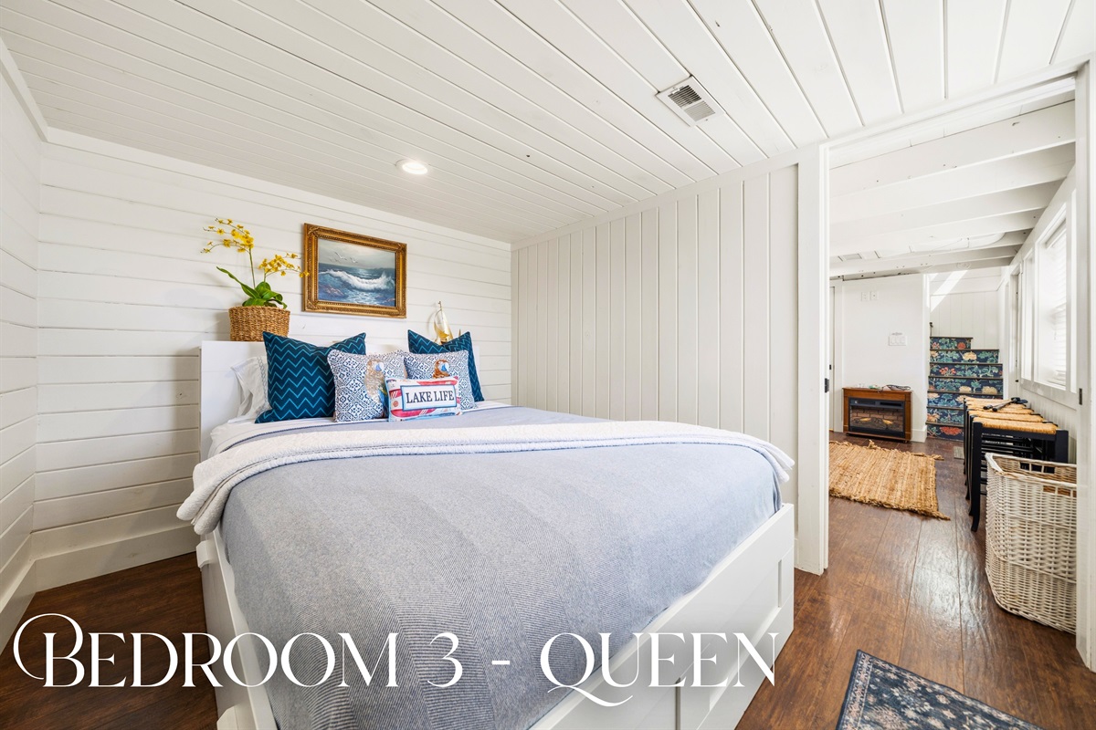 Relax in this queen bedroom where soft lighting, comfortable bedding, and a warm, inviting feel make it a great place to unwind.