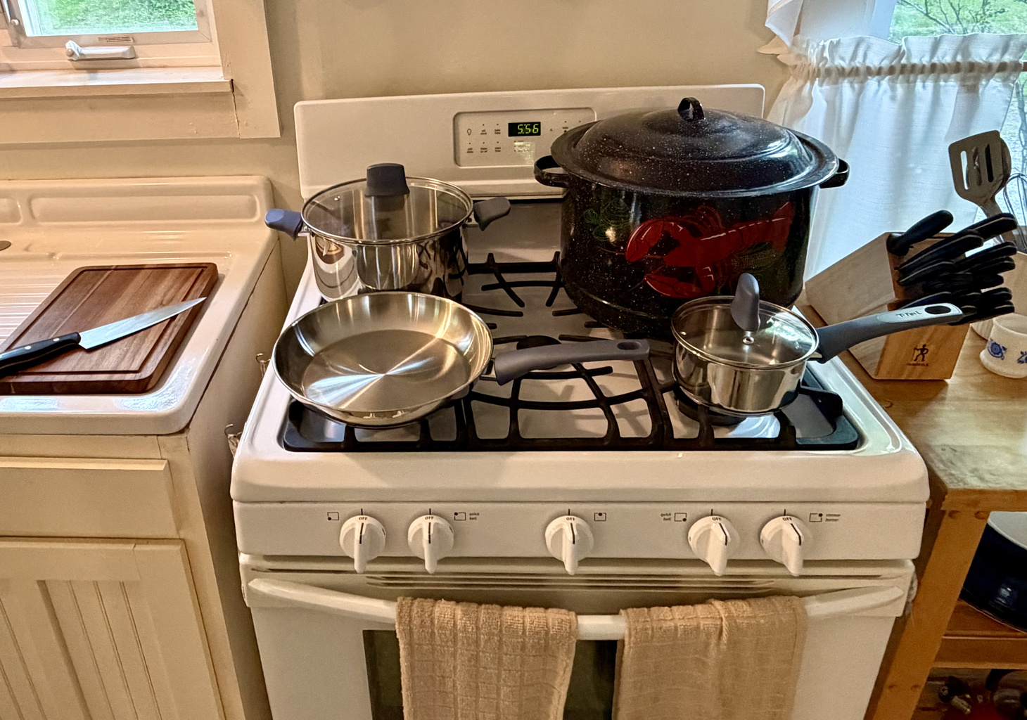 A fully equipped kitchen featuring gas cooking, a classic Maine lobster pot, brand-new stainless cookware, and a premium J.A. Henckels knife set. Everything a home chef needs to prepare fresh local seafood after a day in Acadia.