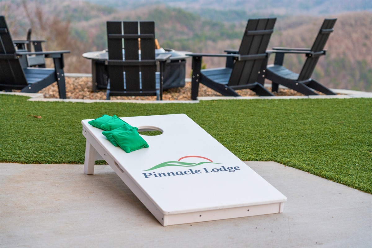 Challenge friends and family to a friendly game of cornhole while enjoying the open yard and mountain backdrop.