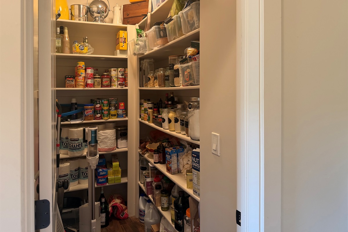 Oversized walk-in pantry stocked with plenty of space for extended family stays and vacation essentials.