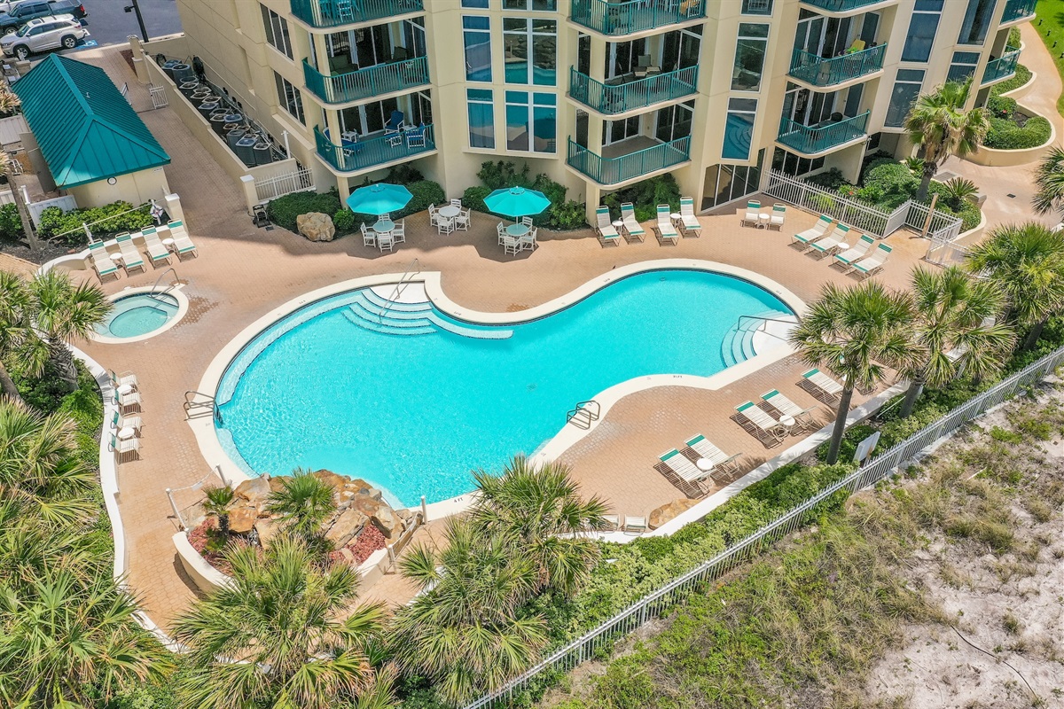 Large, Heated Seasonally, Resort Style Pool with plenty of lounge seating overlooking the Gulf of Mexico + a Hot Tub