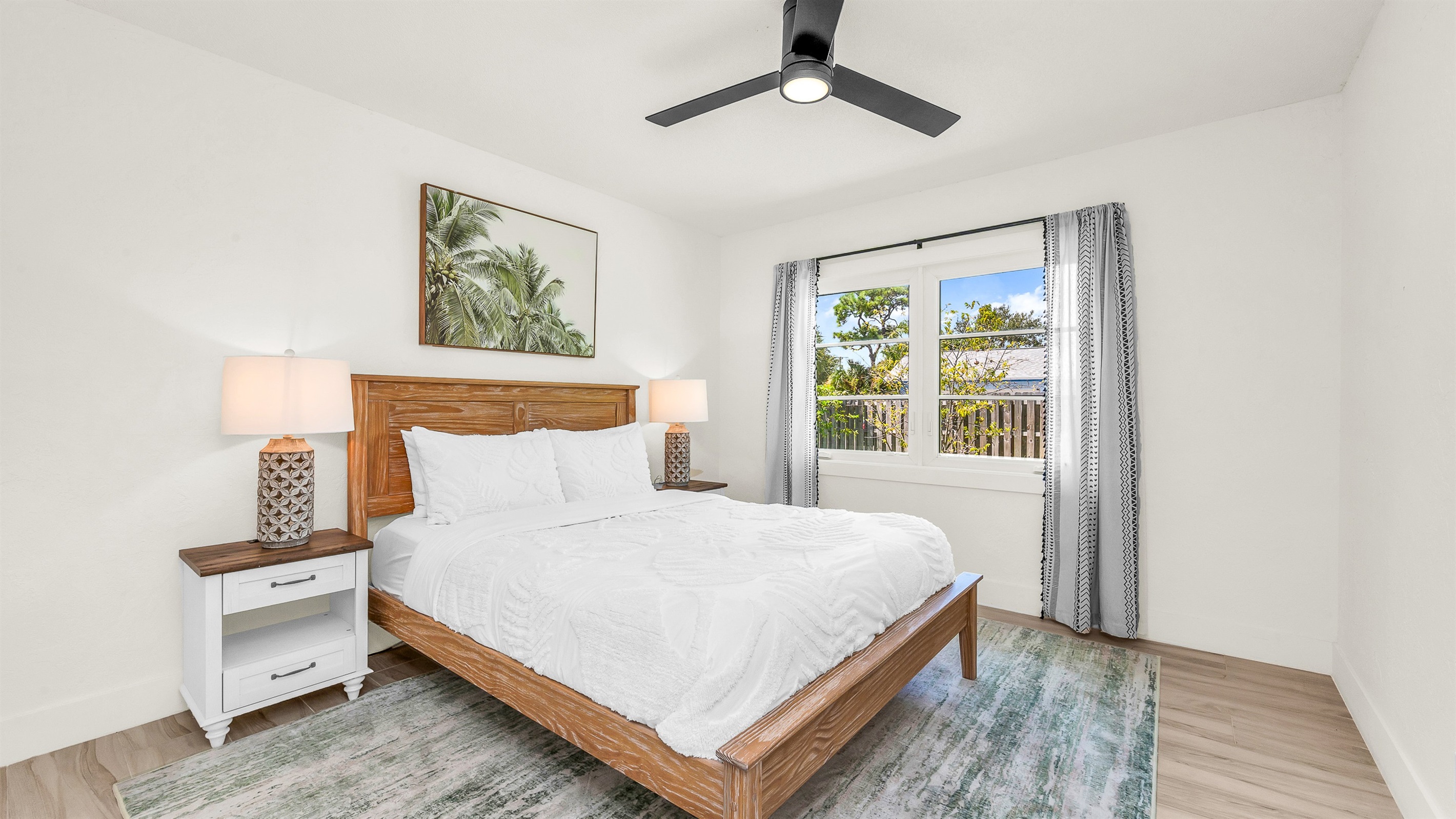 Bedroom 2 offers a relaxing coastal vibe with crisp linens, warm natural light and elegant decor- perfect for guests seeking comfort and tranquility after a day in paradise
